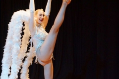 Las Vegas showgirl kicking leg high in silver costume