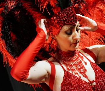 Las Vegas Showgirls in red costume and feather headpiece