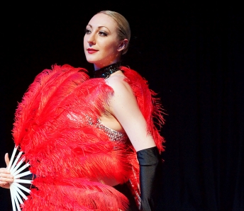 Las Vegas Showgirls in red costume and feather fan