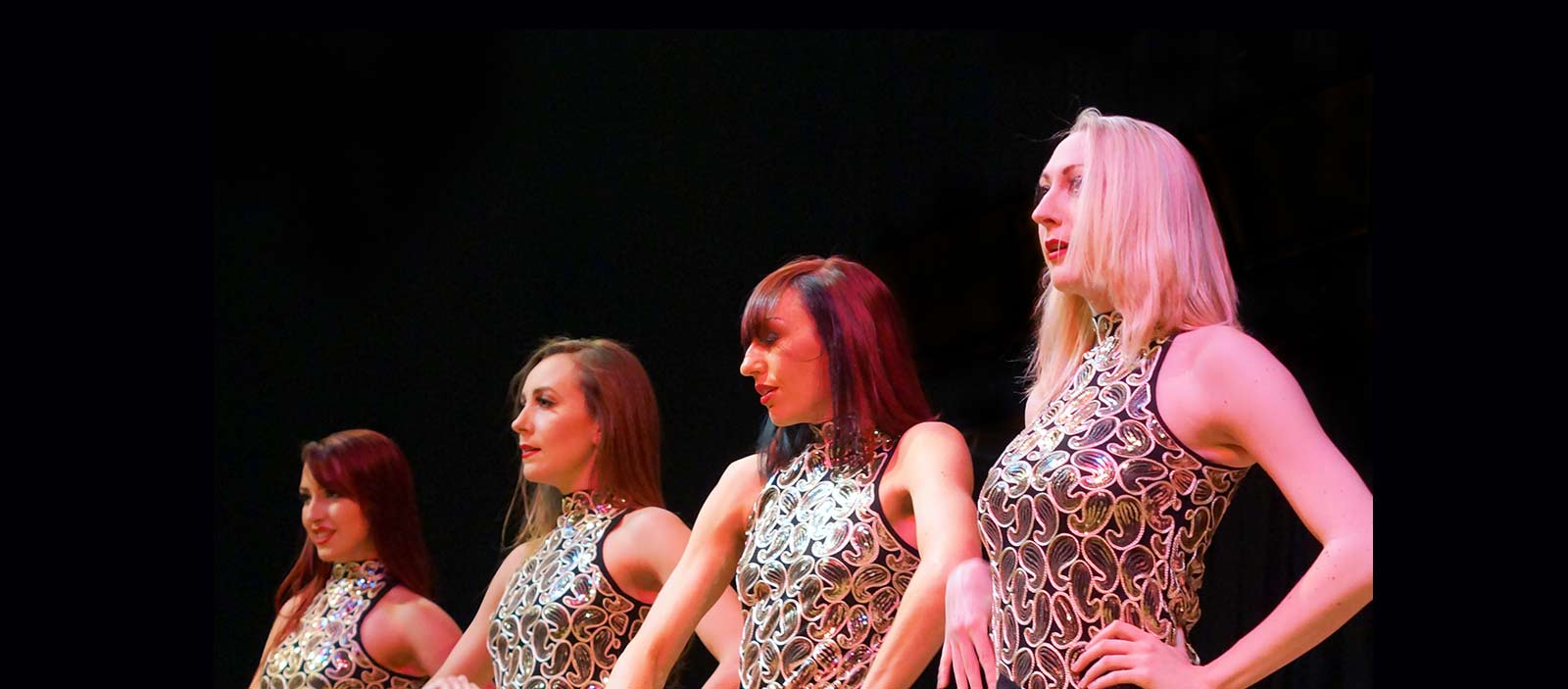 Female dancers in  gold costumes