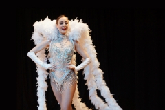 Las Vegas Showgirl with silver costume and feather accessory